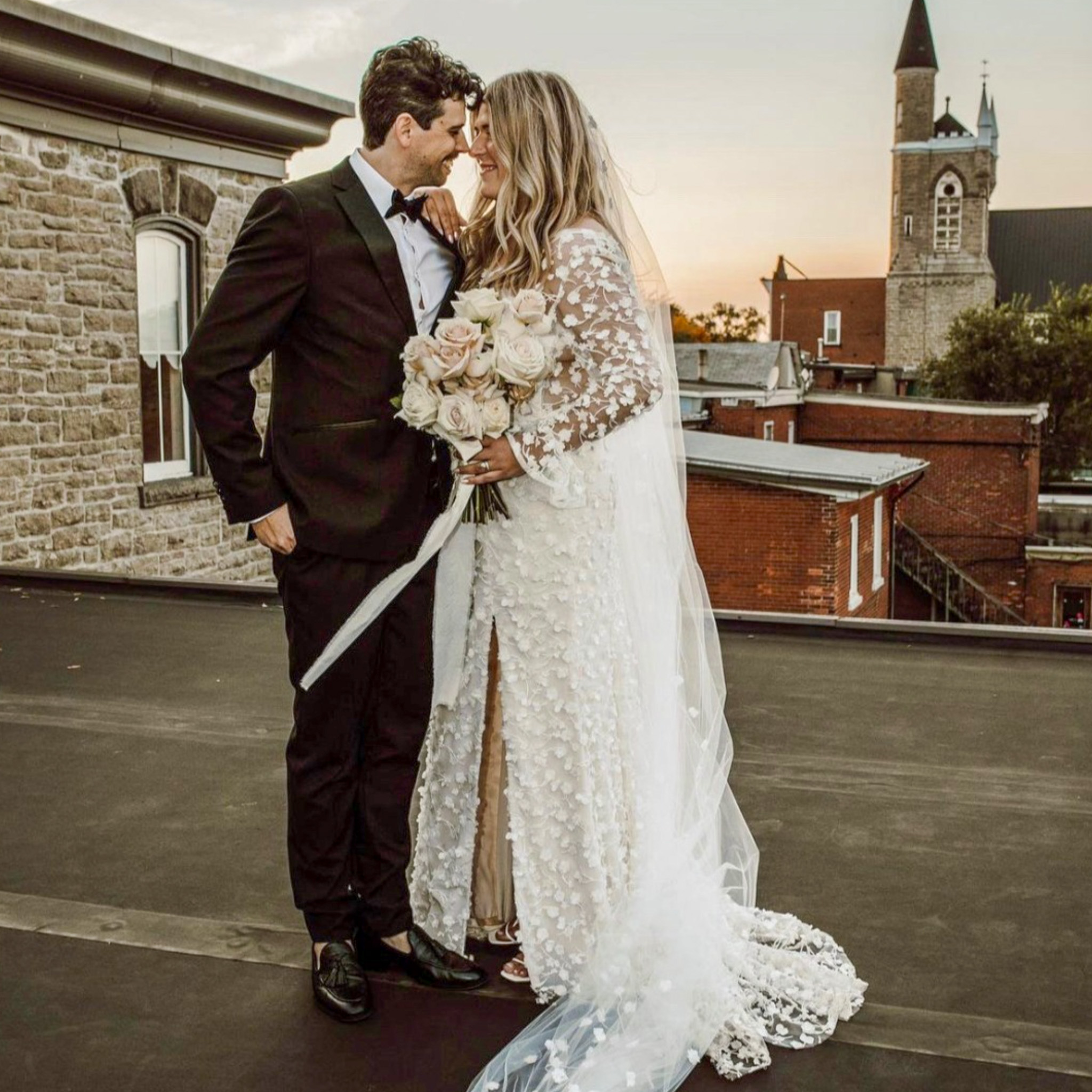 Just Married Couple on the roof of the grand hotel at sunset